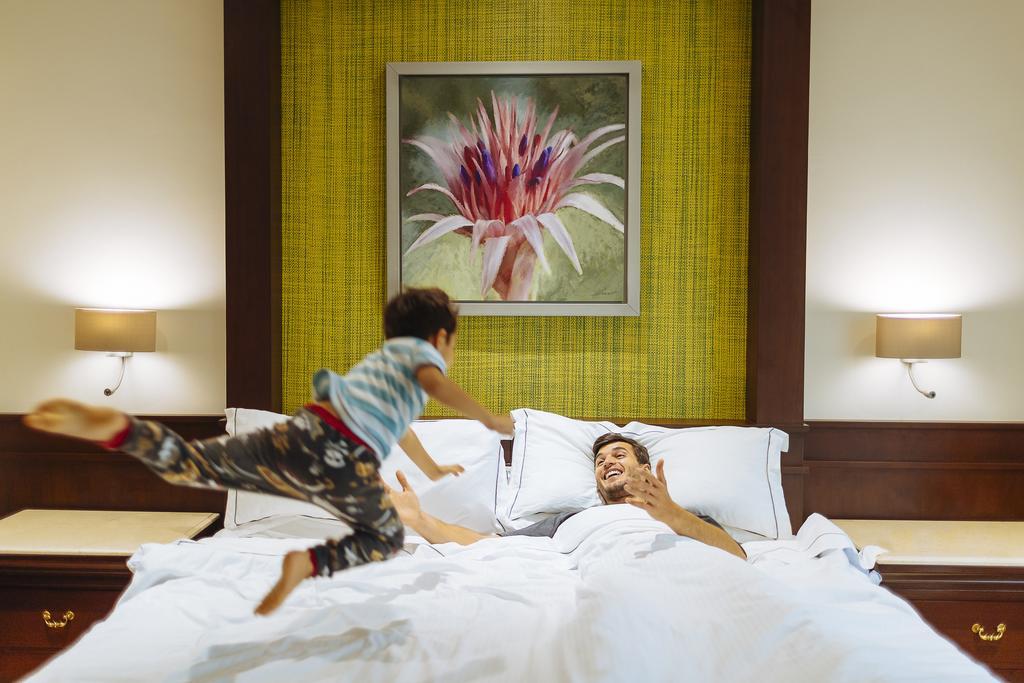 Occidental At Xcaret Destination Hotel Xcaret Park Luaran gambar A child jumps on a bed.